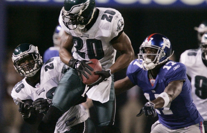 Former Philadelphia Eagles safety Brian Dawkins catches and runs with the football.