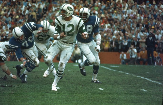 Former New York Jets quarterback Joe Namath runs from an opponent.