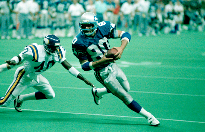 Former Seattle Seahawks wide receiver Steve Largent runs with the football.