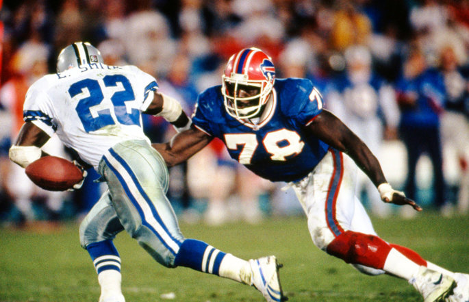Former Buffalo Bills defensive end Bruce Smith moves to tackle an opponent with the football.