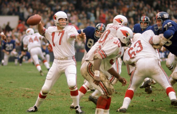 Former Arizona Cardinals quarterback Jim Hart passes the football.