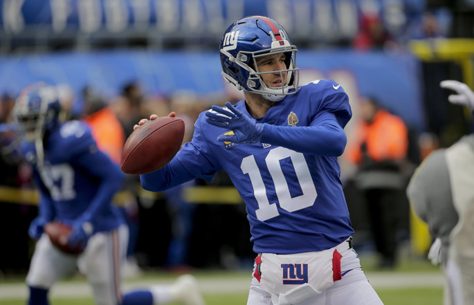 Former New York Giants quarterback Eli Manning passes the football.