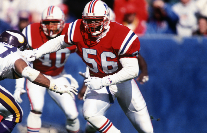 Former New England Patriots linebacker Andre Tippett runs towards an opponent.