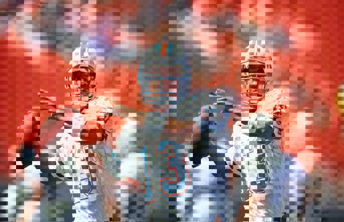 Former Miami Dolphins quarterback Dan Marino passes the football.