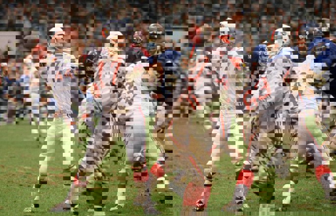 Former Arizona Cardinals quarterback Jim Hart passes the football.